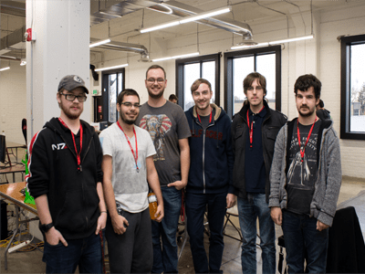 Group of LAN Party participants standing together smiling.